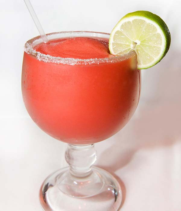 Fresh signature watermelon margaritas made with tequila and a salted rim served at Mariachis Mexican Restaurant in Brenham, TX