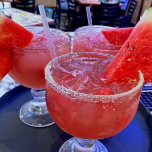 Fresh signature watermelon margaritas made with tequila and a salted rim served at Mariachis Mexican Restaurant in Brenham, TX